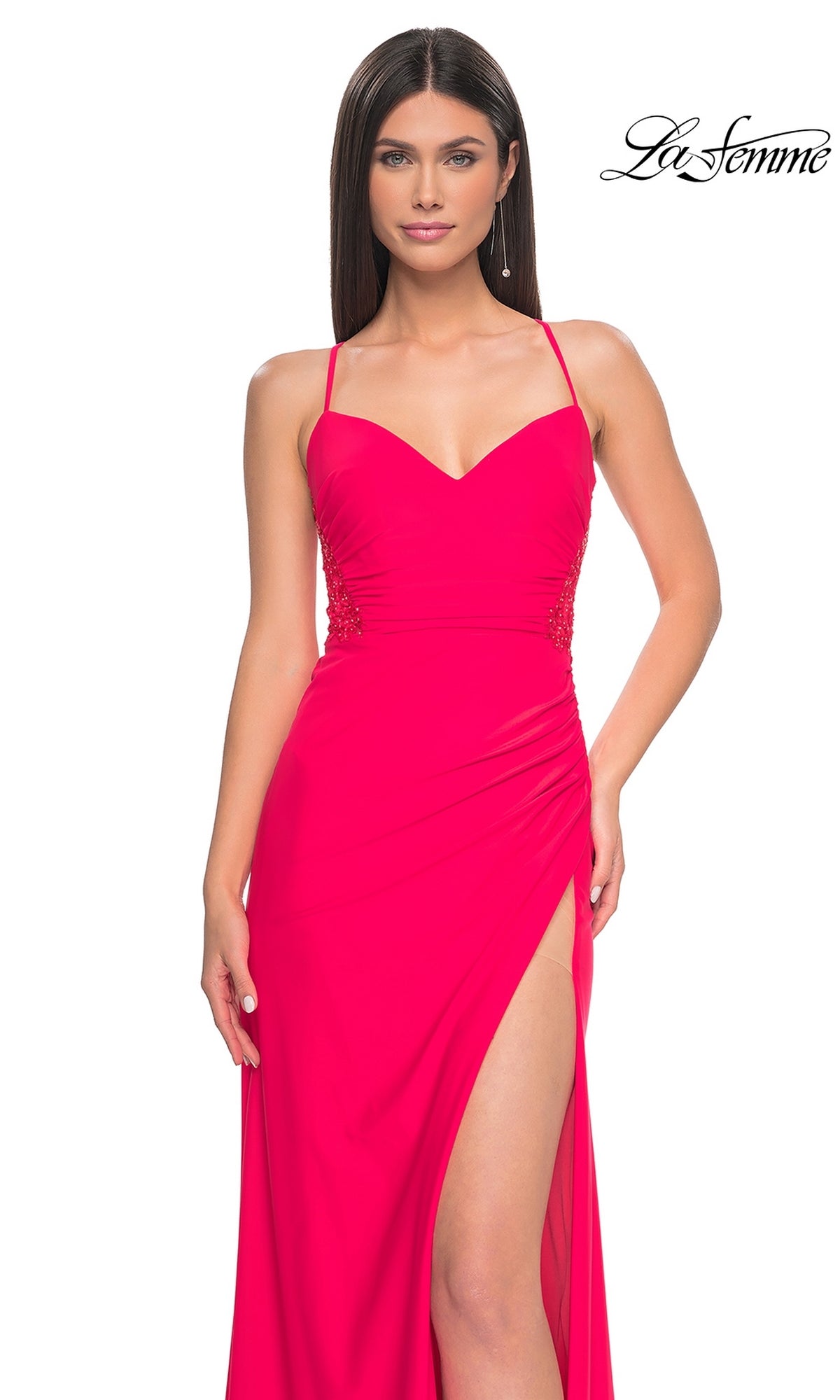 Woman wearing the La Femme Bright Hot Coral Long Prom Dress 31440, featuring a sweetheart neckline, thin straps, and a high leg slit, standing against a white background.
